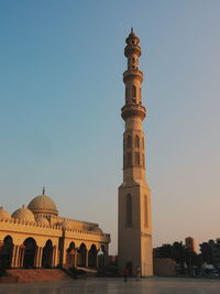 Low angle view of tower by mosque