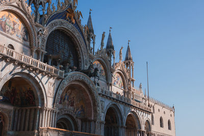 Low angle view of historic building against clear blue sky