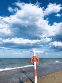 Lifeguard hut on beach against sky