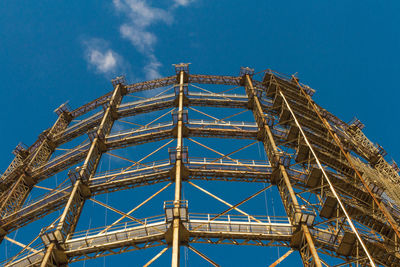 Low angle view of crane against blue sky