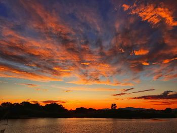 Scenic view of lake against orange sky