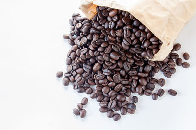 High angle view of coffee beans against white background
