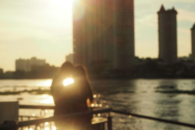 View of city lit up at sunset