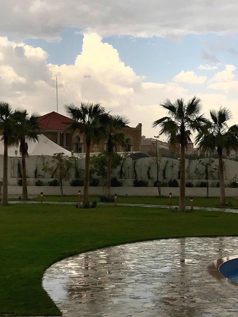 cloud - sky, architecture, sky, built structure, tree, building exterior, day, grass, palm tree, outdoors, water, travel destinations, no people, nature, landscape, beauty in nature