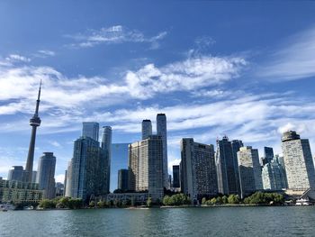 View of buildings in city against cloudy sky