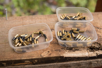 High angle view of bullets in container on table