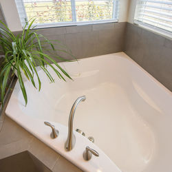 Low section of person washing hands in bathroom