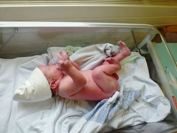 Newborn baby sleeping in crib at home