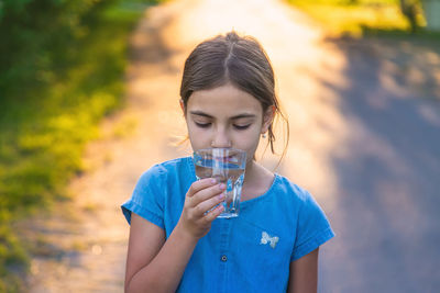 Girl drinking water at park