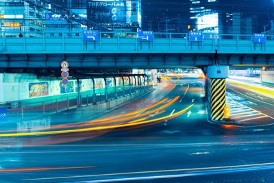 Light trails on road in city at night