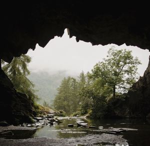 Scenic view of mountains seen through cave