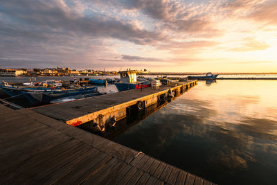 Pier over sea against sky during sunset