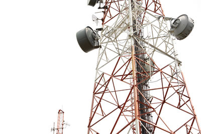 Low angle view of electricity pylon against clear sky