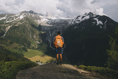 Man hiker standing on a hilltop in the french alps, le tour, france