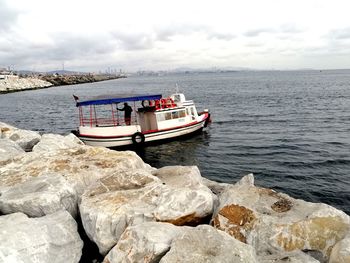 Boat sailing on sea against sky