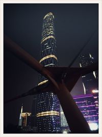 Low angle view of illuminated building against sky at night