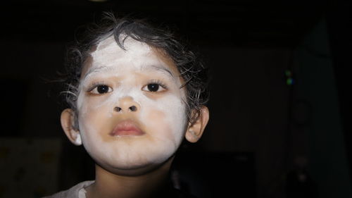 Close-up of boy with powder on face