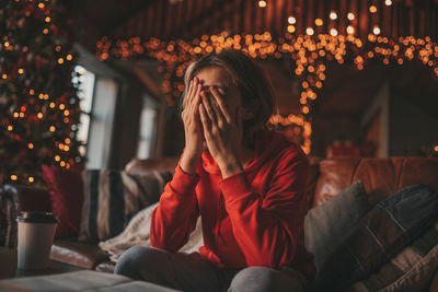 Portrait of candid authentic dreamer boy teenager in sadness depressing emotion at home xmas