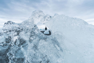 People skiing on snowcapped mountain against sky