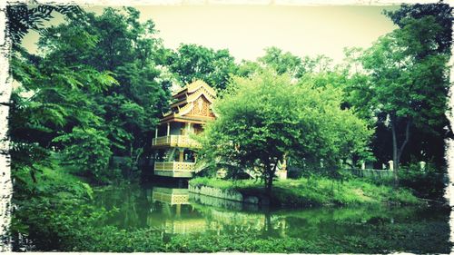 Calm lake with buildings in background