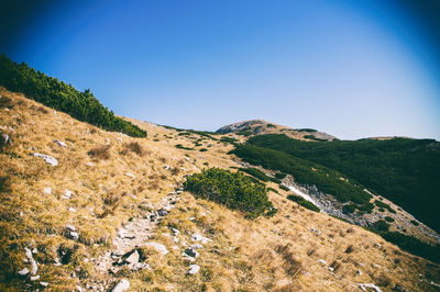 Scenic view of mountains against clear blue sky