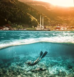 Women scuba diving in sea