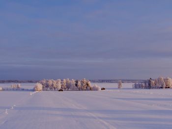 Scenic view of snow covered landscape against sky