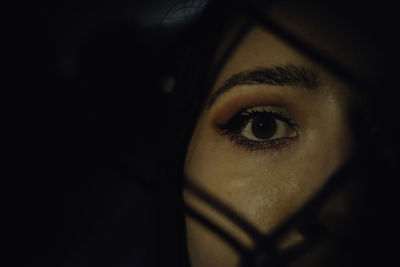 Close-up of young woman face in darkroom