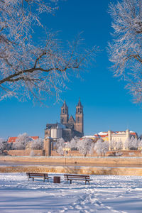 View of buildings against blue sky during winter