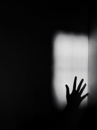Shadow of person hand on wall