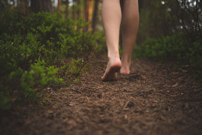 Low section of woman walking on ground