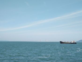 Boat sailing in sea against sky