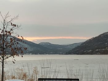 Scenic view of snowcapped mountains against sky during sunset