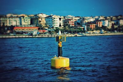 Sea against buildings in city