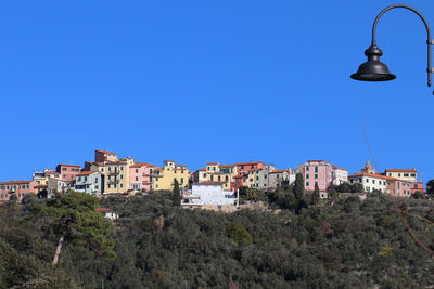 Low angle view of buildings against clear blue sky