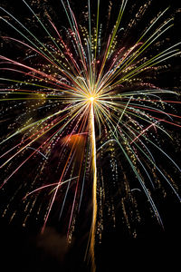 Low angle view of firework display at night