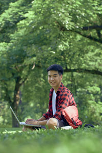 Young man sitting outdoors