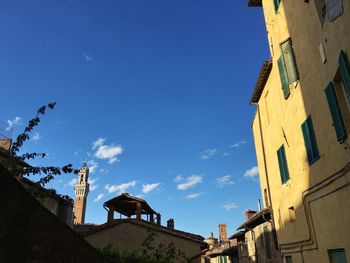 Low angle view of residential buildings against blue sky