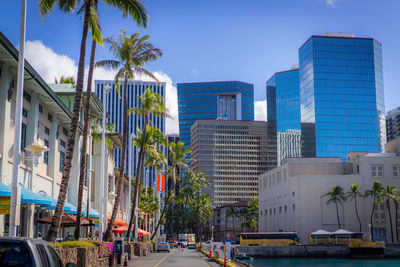 Buildings in city against blue sky