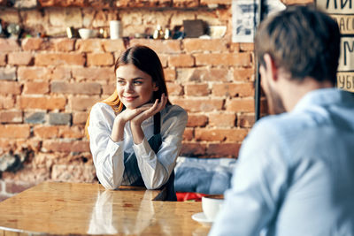 Young couple sitting on table