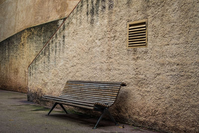 Deck chairs against brick wall