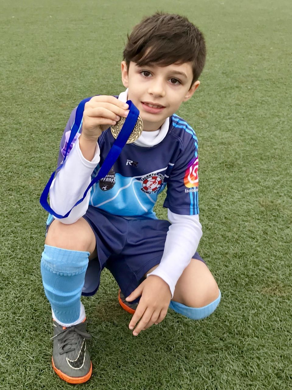 PORTRAIT OF HAPPY BOY ON FIELD