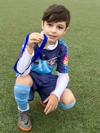 Portrait of boy smiling on field