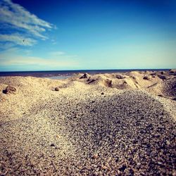 Scenic view of beach against blue sky