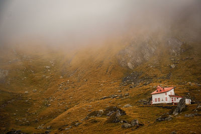 High angle view of house on mountain against sky