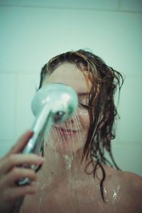 Woman taking shower in bathroom