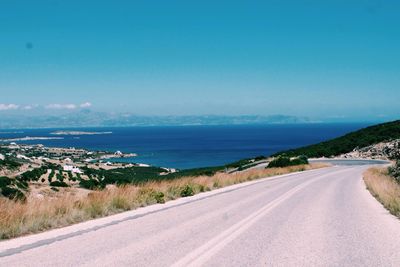 Road by sea against sky