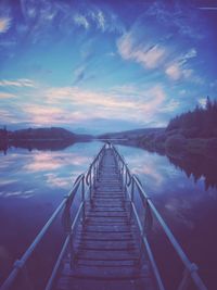 Pier over lake against sky