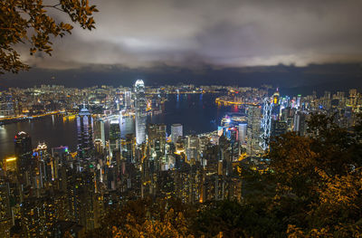 High angle view of illuminated buildings against sky at night