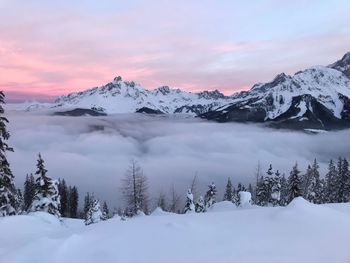 Scenic view of snow covered mountains against sky during sunset